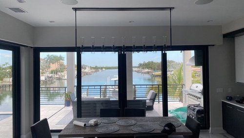 Finished dining area overlooking the water after a waterfront remodel.